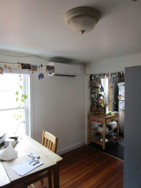 Indoor installation of heating and cooling ductless system in Somerville two-family home.