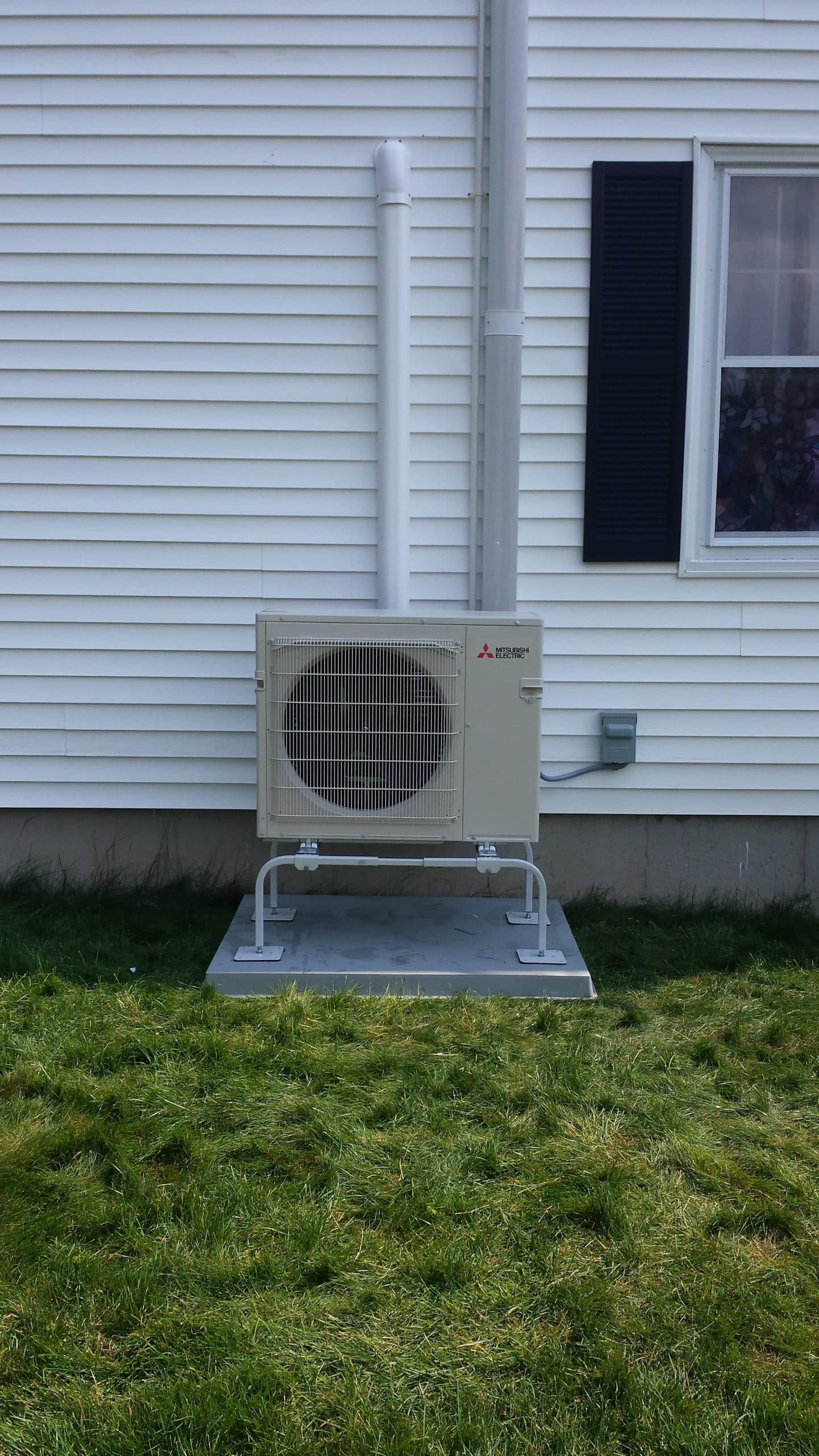 Installation of an outdoor unit for this home’s Mitsubishi mini split system.