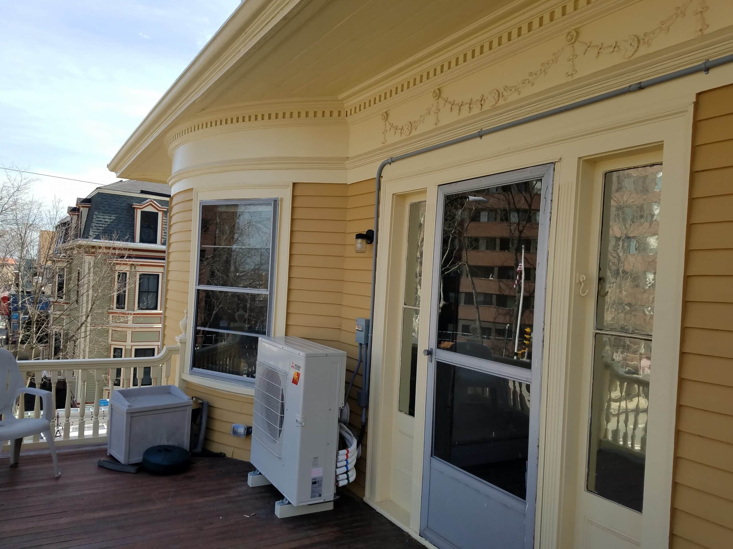 Outdoor heat pump unit for ductless system in Victorian home.