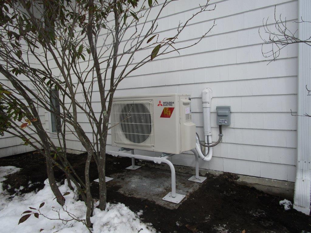 Outdoor heat pump installation in Concord, MA contemporary home.