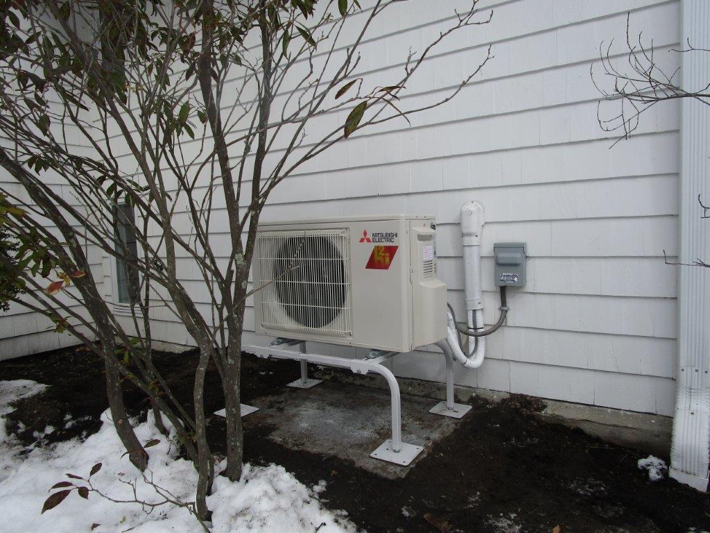 Outdoor heat pump installation in Concord, MA contemporary home. 