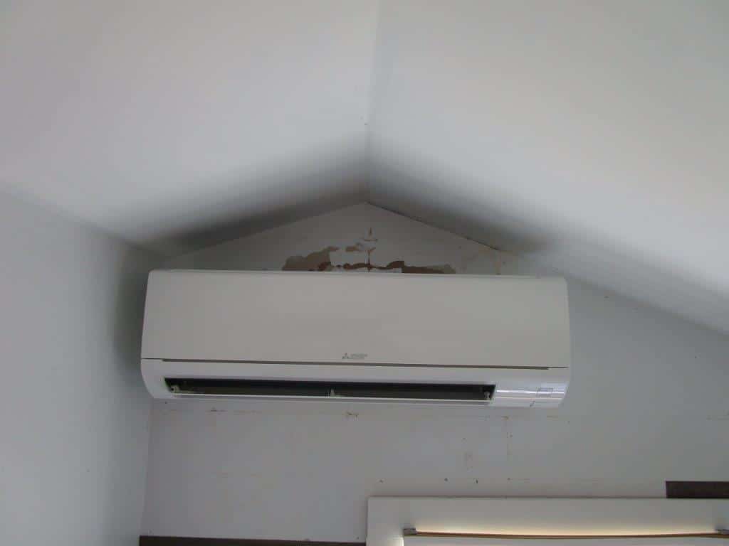 Indoor wall AC unit for ductless system in New England cottage.