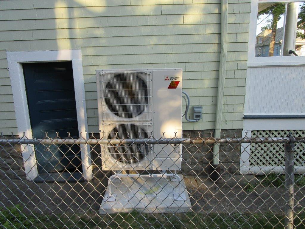 Outdoor heat pump powers Mitsubishi ductless units in Arlington, MA