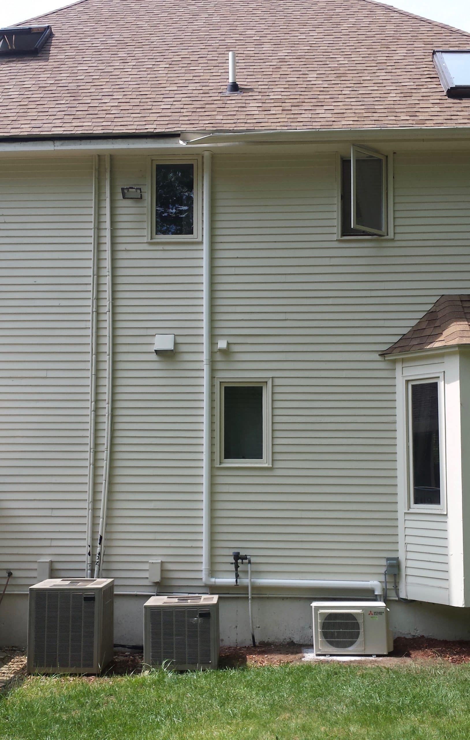 Outdoor installation of ductless condenser in Allston MA home 