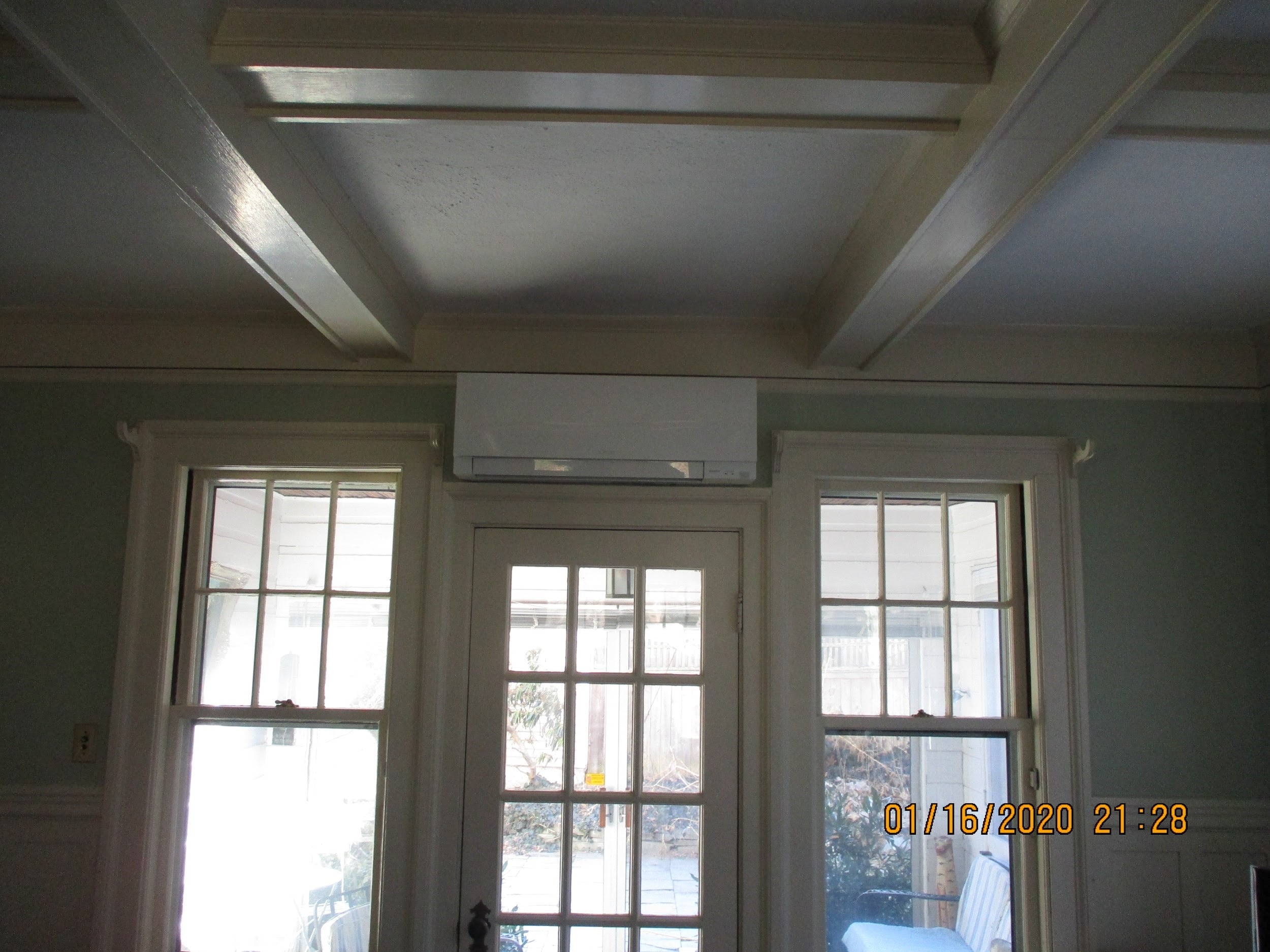 Ductless AC mounted above the doorway in Winchester, MA.