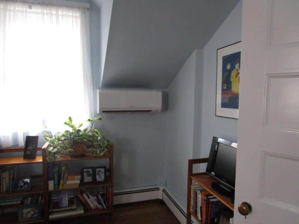 Ductless AC unit installed on the wall of a home for Mitsubishi ductless HVAC system.