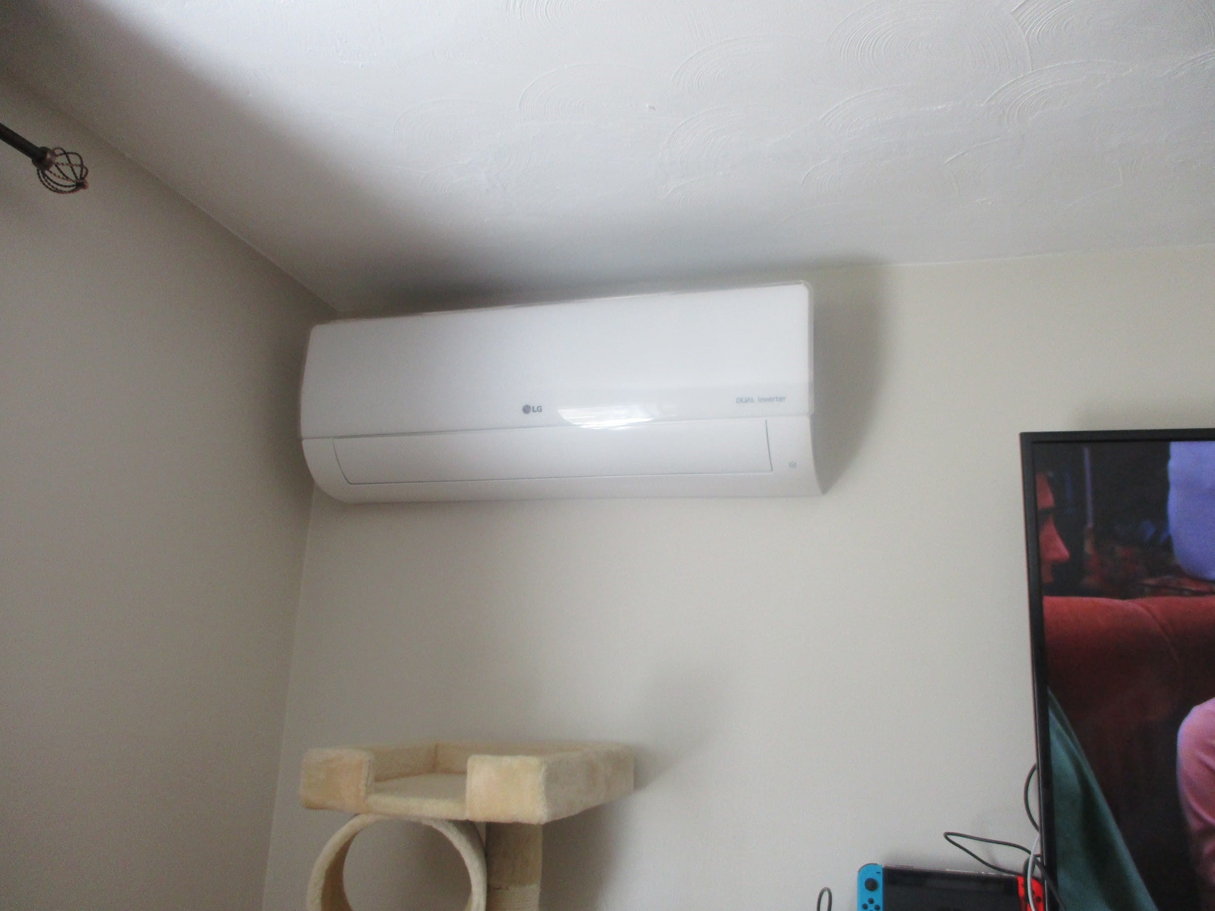 Example of a ductless wall AC installed in a split-level ranch family room. 