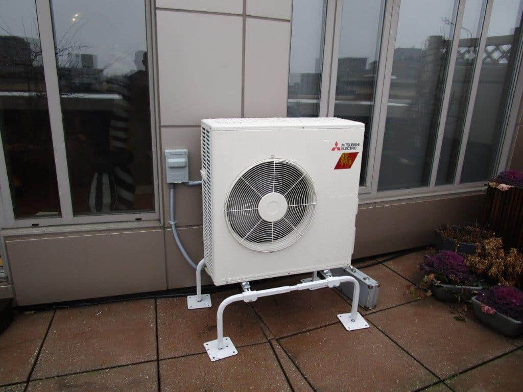 Balcony installation of outdoor unit for ductless system in Boston.