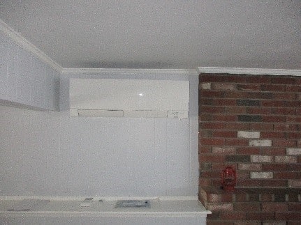 Indoor ductless AC wall cassette installed in Andover family room.