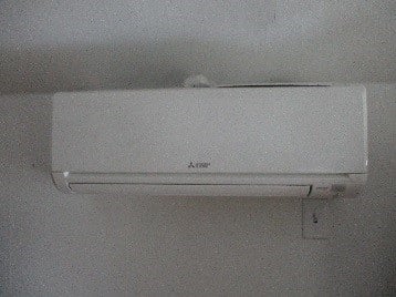 Indoor ductless wall AC installed in multi-family home.