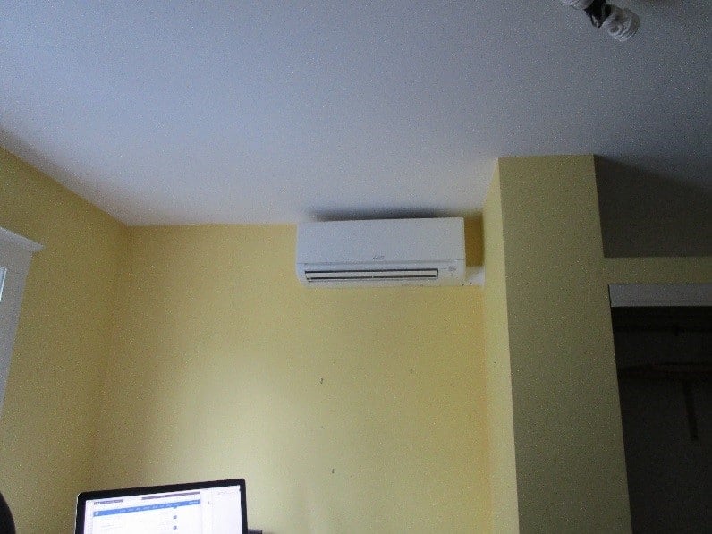 Indoor installation of ductless air conditioning unit with Mitsubishi Hyper-Heating technology.