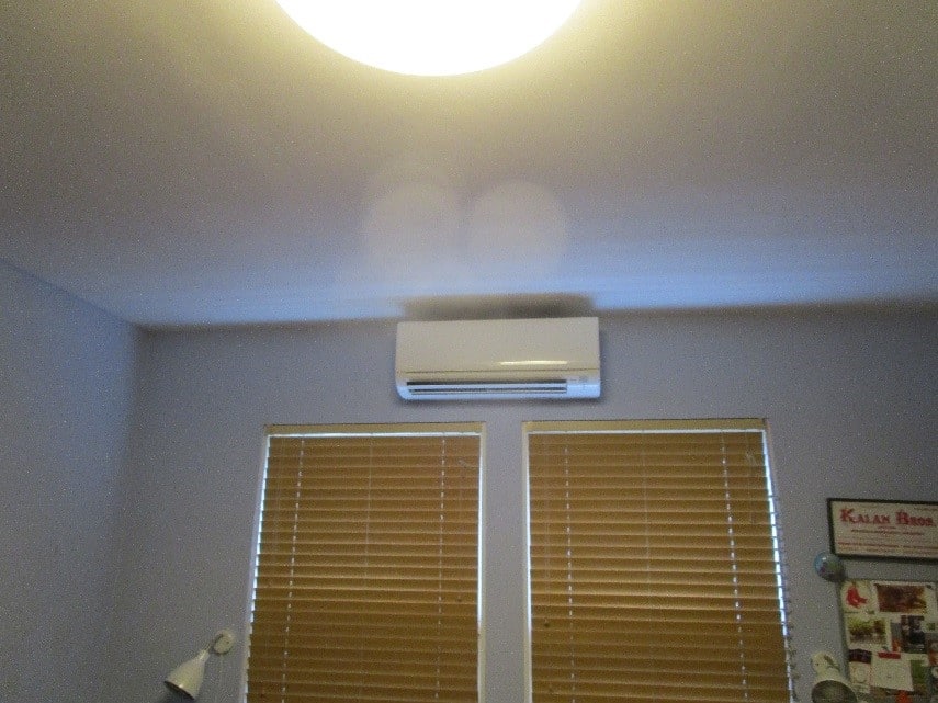 Indoor wall ductless AC unit installation in multi-family home.