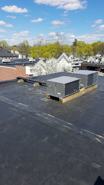 Industrial freezer compression unit installed on rooftop in Andover, MA.