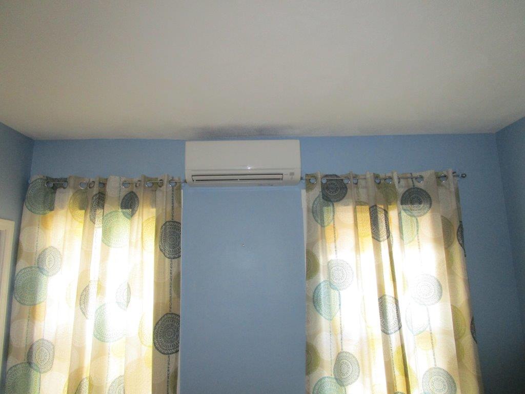 Wall unit installation of ductless heating and air in Boston.