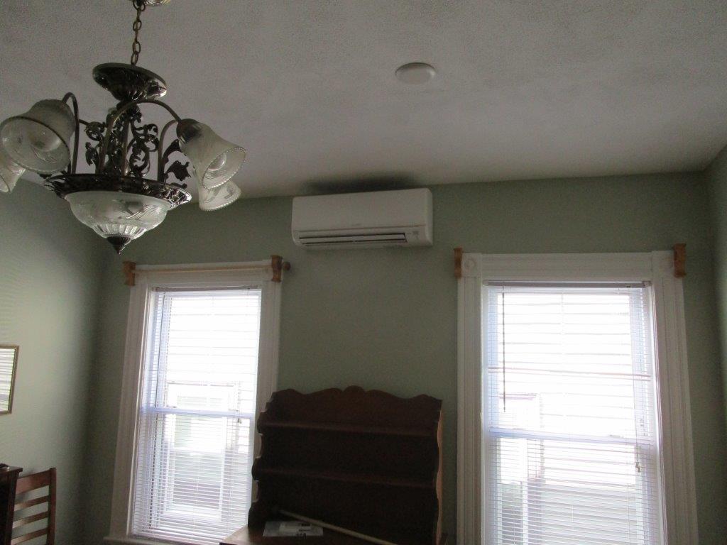 Indoor installation of ductless wall unit in Boston home.