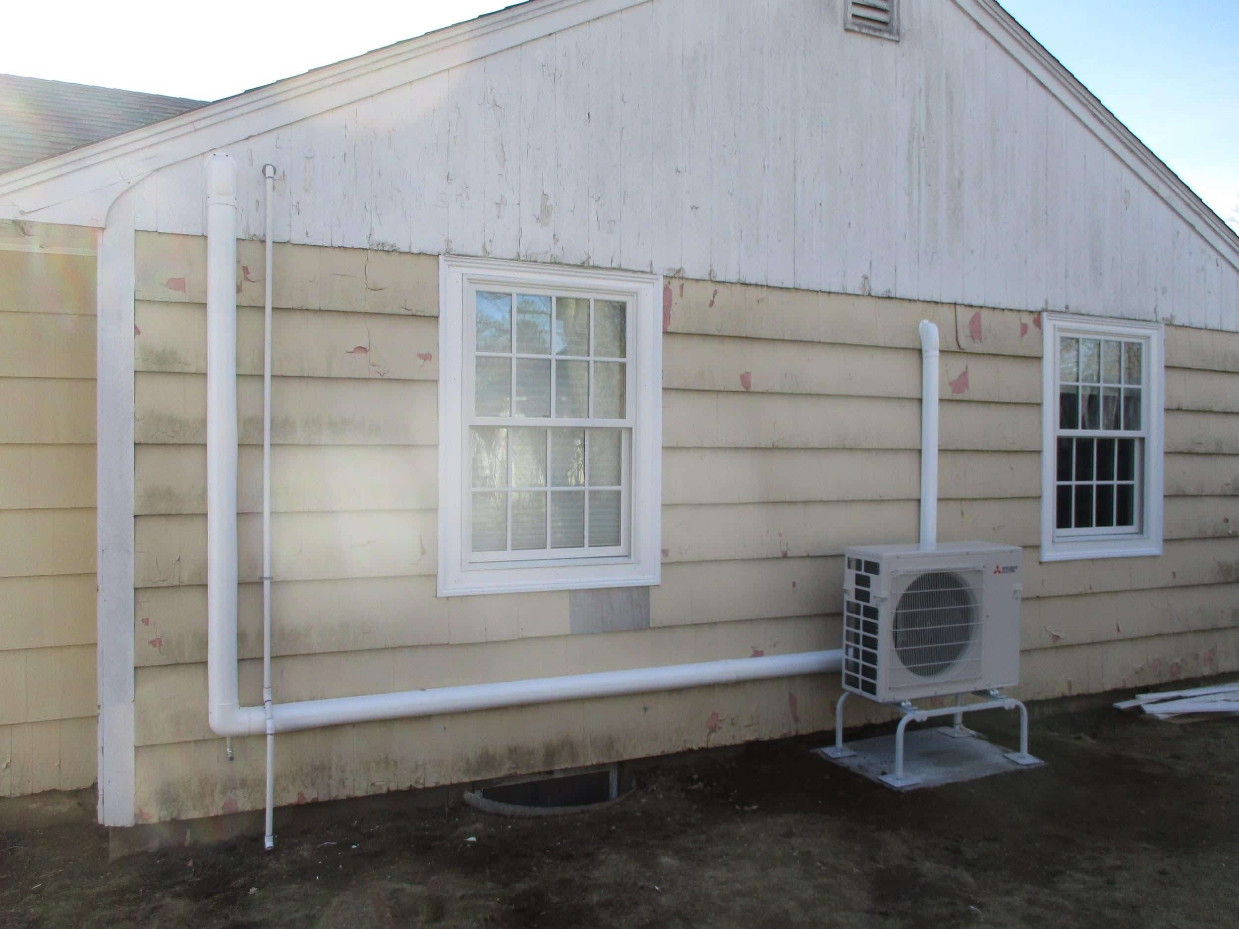 Outdoor condenser and heat pump installed for Mitsubishi ductless system in Hamilton, MA.