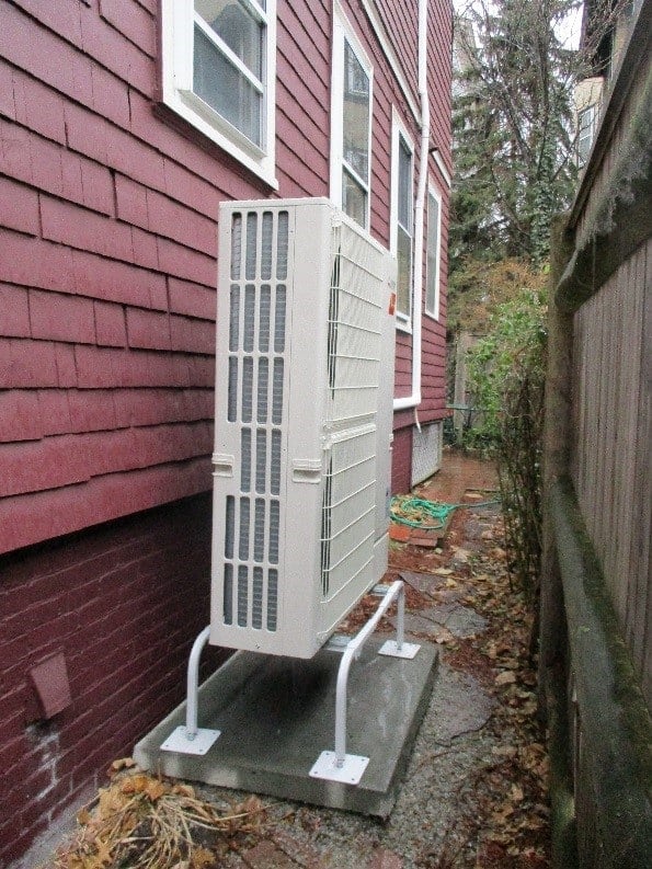 Outdoor condenser for Mitsubishi ductless Hyper-Heating system for multi-family home in Cambridge.