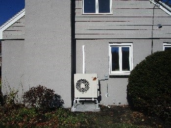 Outdoor condenser installed in Woburn, MA home for Mitsubishi ductless.