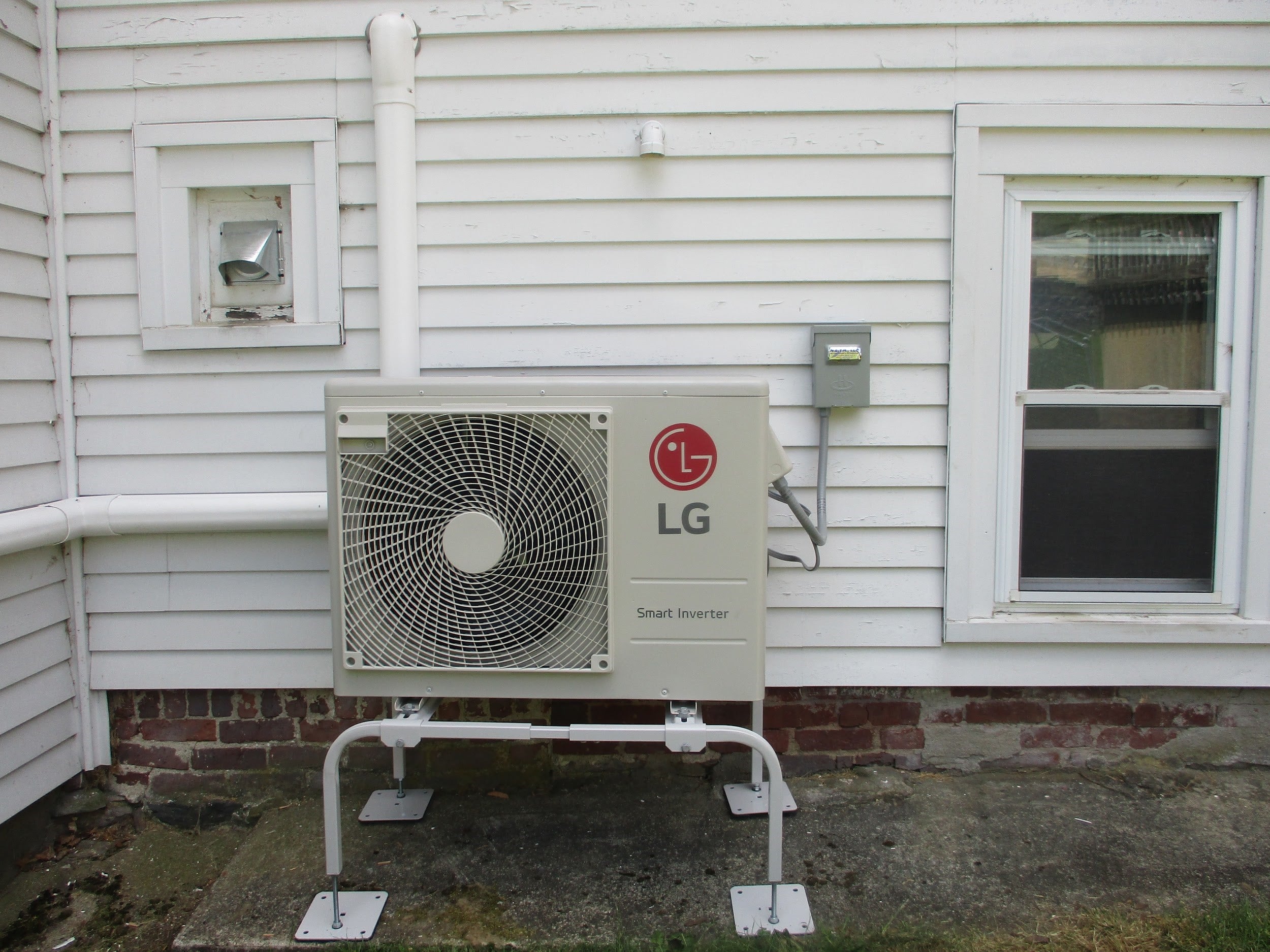 Outdoor heat pump with line piping installed outside Marlborough home. 