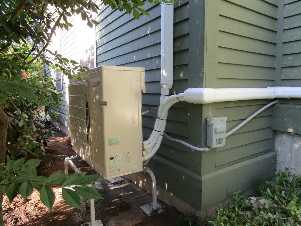 Outdoor Mitsubishi ductless condenser unit installed in Newbury, MA.