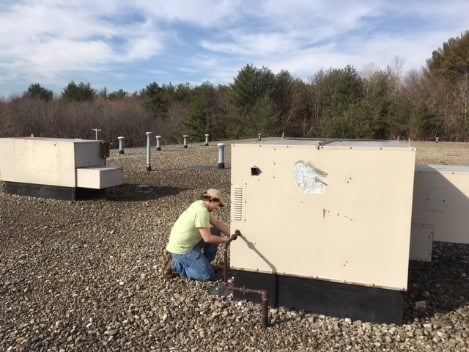 Rooftop condenser unit for smaller heating system in Dracut, MA, business.