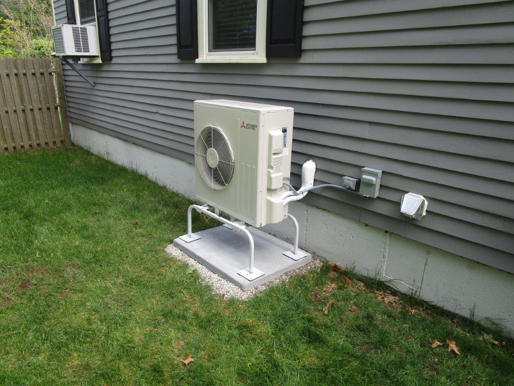 Outdoor Mitsubishi ductless heat pump condenser in Wenham MA