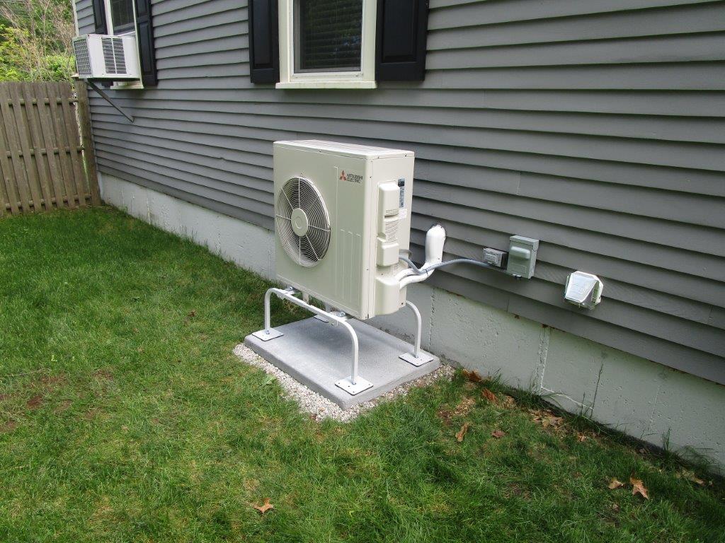 Outdoor Mitsubishi ductless heat pump condenser in Wenham MA