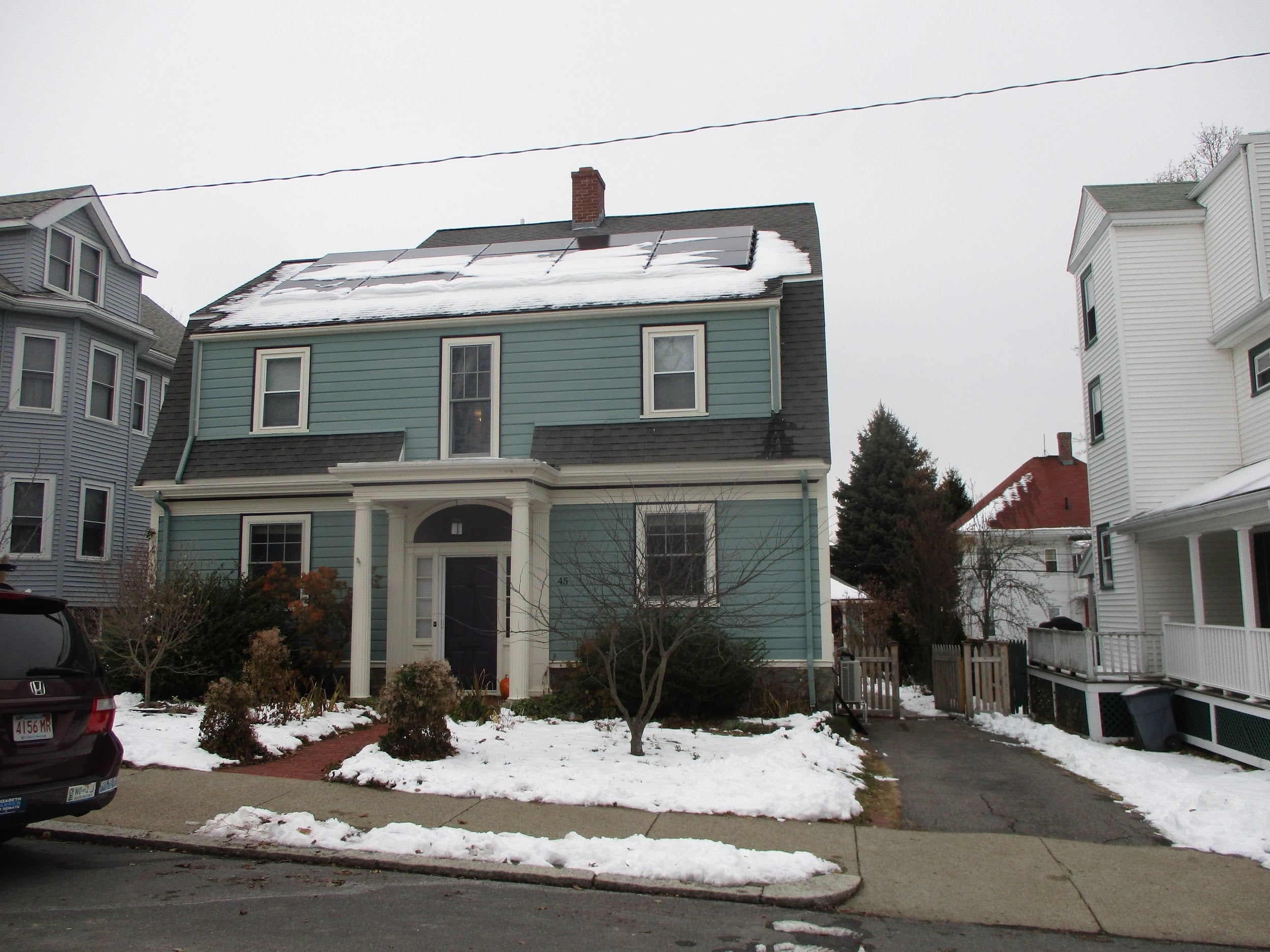 Two-story Dutch Colonial home in Roslindale, MA, upgrades window ACs to ductless.