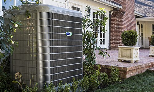 Carrier 16 Seer AC condenser unit installed outside Winchester, MA, home.