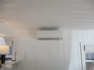 A Mitsubishi ductless AC unit installed on the wall of a cottage in Old Town.