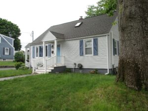 Cape-style home in Lowell, MA, upgrades old AC system with an American Standard HVAC system.