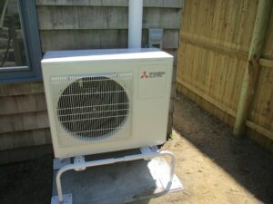 Example of a Mitsubishi ductless condenser unit installed outside a home for AC replacement project.