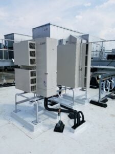 Mitsubishi ductless AC system condenser installed on the roof on the Moderna building. 