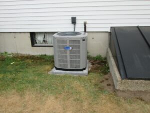 Outdoor condenser unit for American Standard system installed in dual townhouses.