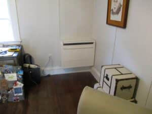 An example of a new Mitsubishi Electric ductless AC air handler installed in the second-floor bedroom of this colonial home.