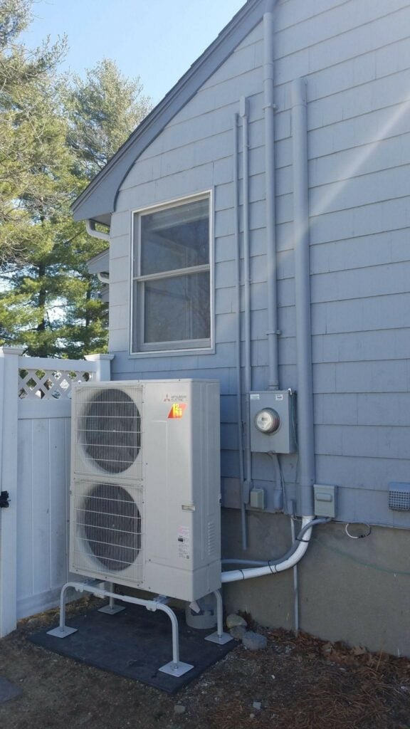 Example of an outdoor condenser unit installed outside a ranch home in Arlington for Mitsubishi Electric AC system. 