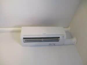 Indoor air handler for Mitsubishi ductless AC system to replace window AC units in Boston home.
