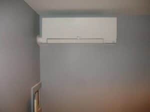 An indoor air handler installed for a Mitsubishi ductless system installed in a Boston home.
