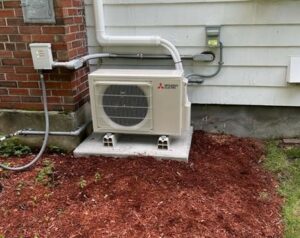 An outdoor condenser from Mitsubishi Electric installed for this ductless AC system.