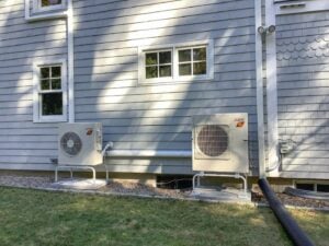 The two outdoor Mitsubishi ductless units with cold-climate heating capabilities for multi-zone heating and cooling system. 