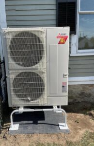 A Mitsubishi Electric heat pump installed outside North Andover home with heating and cooling capabilities. 