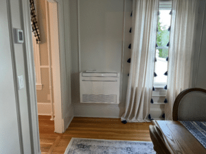 A floor-mounted unit installed in this colonial home for heating and cooling. 