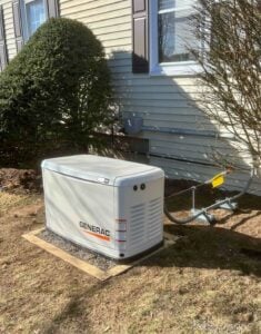 Generac generator installed outside a cape-style home in Quincy.