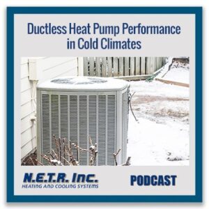 An outdoor heat pump unit sits next to a house with light snow on the ground, illustrating ductless heat pump performance in cold climates.