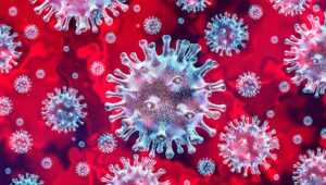 Digital illustration of multiple viruses with spiky surfaces against a red background, representing microscopic view of viral particles.
