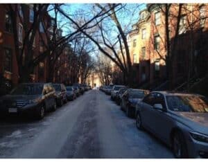 A row of cars parked on a street.