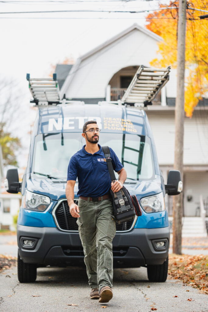 NETR technician in front of van